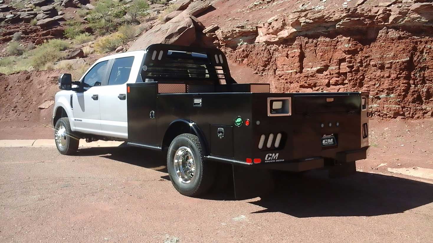 TM towing-style flatbed next to mountain with work light option