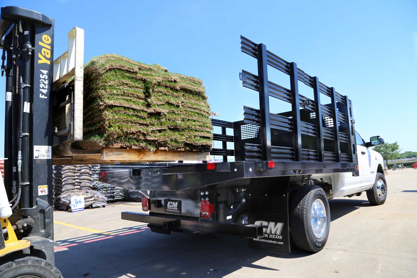 Platfrom truck bed with side stake option loading on grass